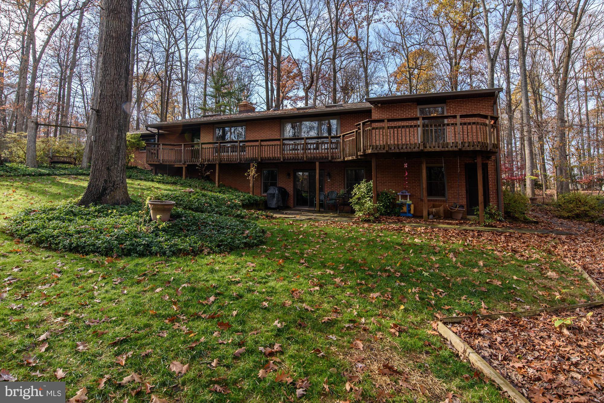 10302 Lloyd Road Potomac, MD 20854 - Photo 29 of 30 a view of a house with a large tree and a yard in front of it