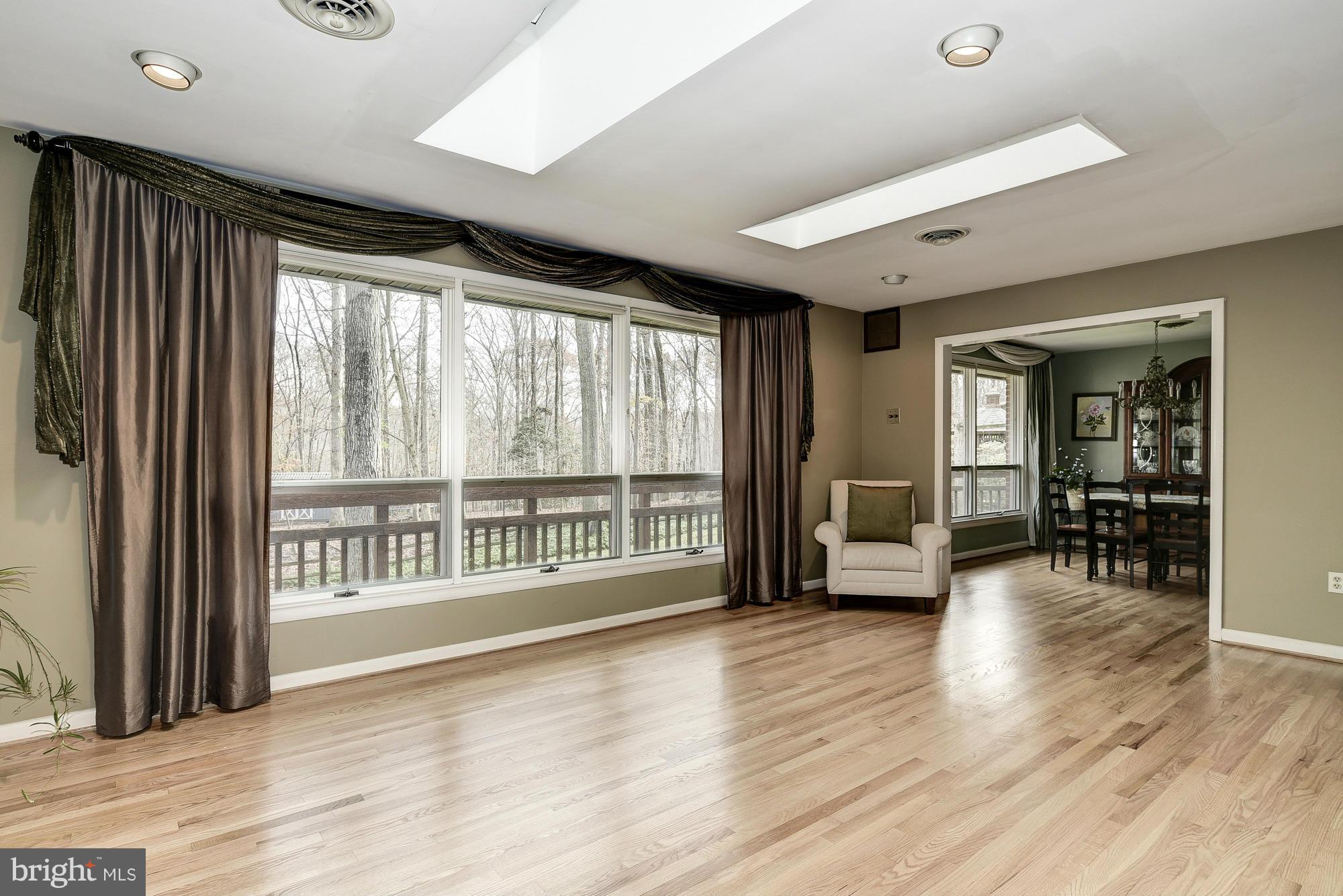 10302 Lloyd Road Potomac, MD 20854 - Photo 6 of 30 a view of an empty room with wooden floor and a window
