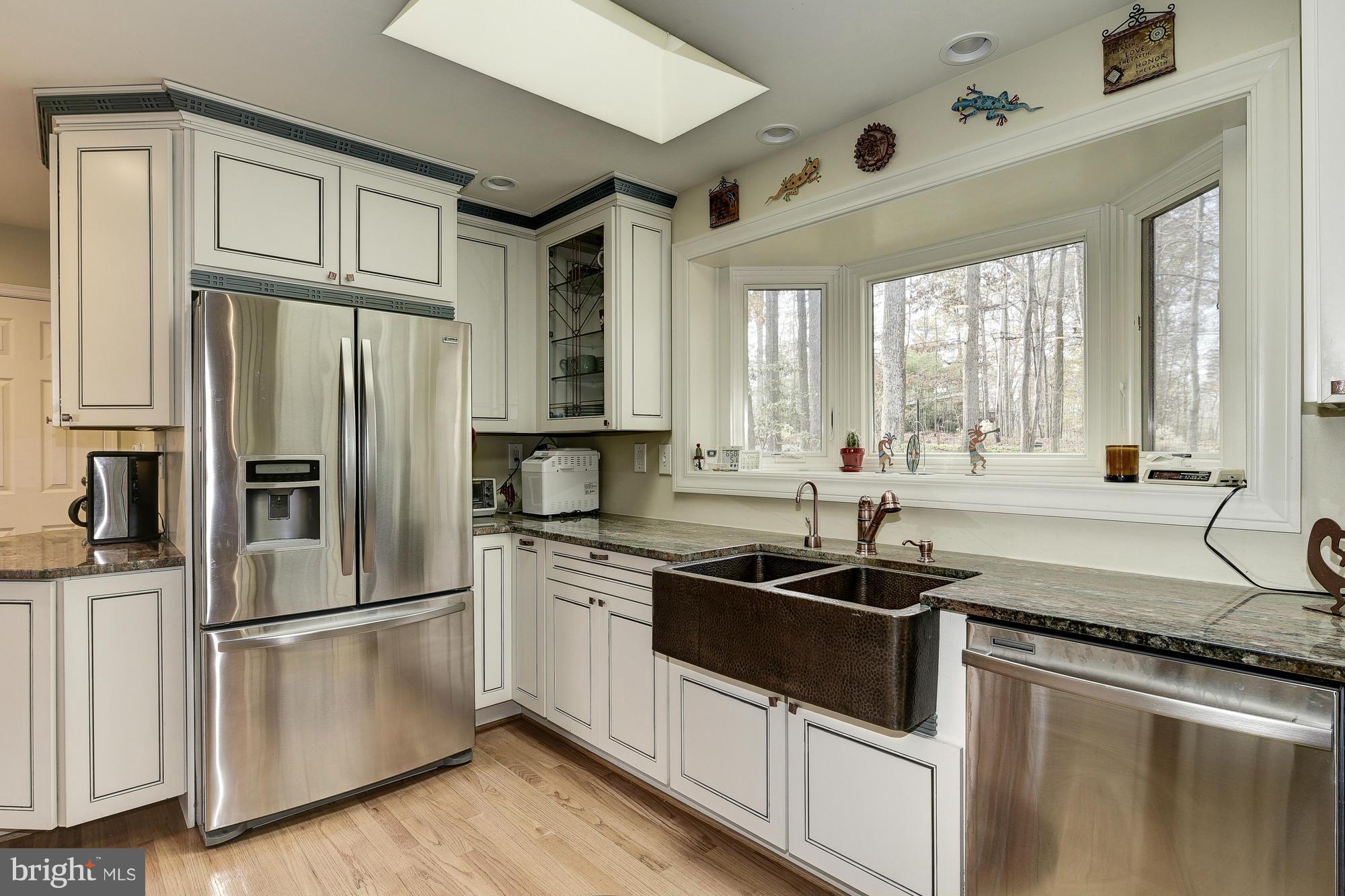 10302 Lloyd Road Potomac, MD 20854 - Photo 10 of 30 a kitchen with stainless steel appliances granite countertop a sink stove and refrigerator