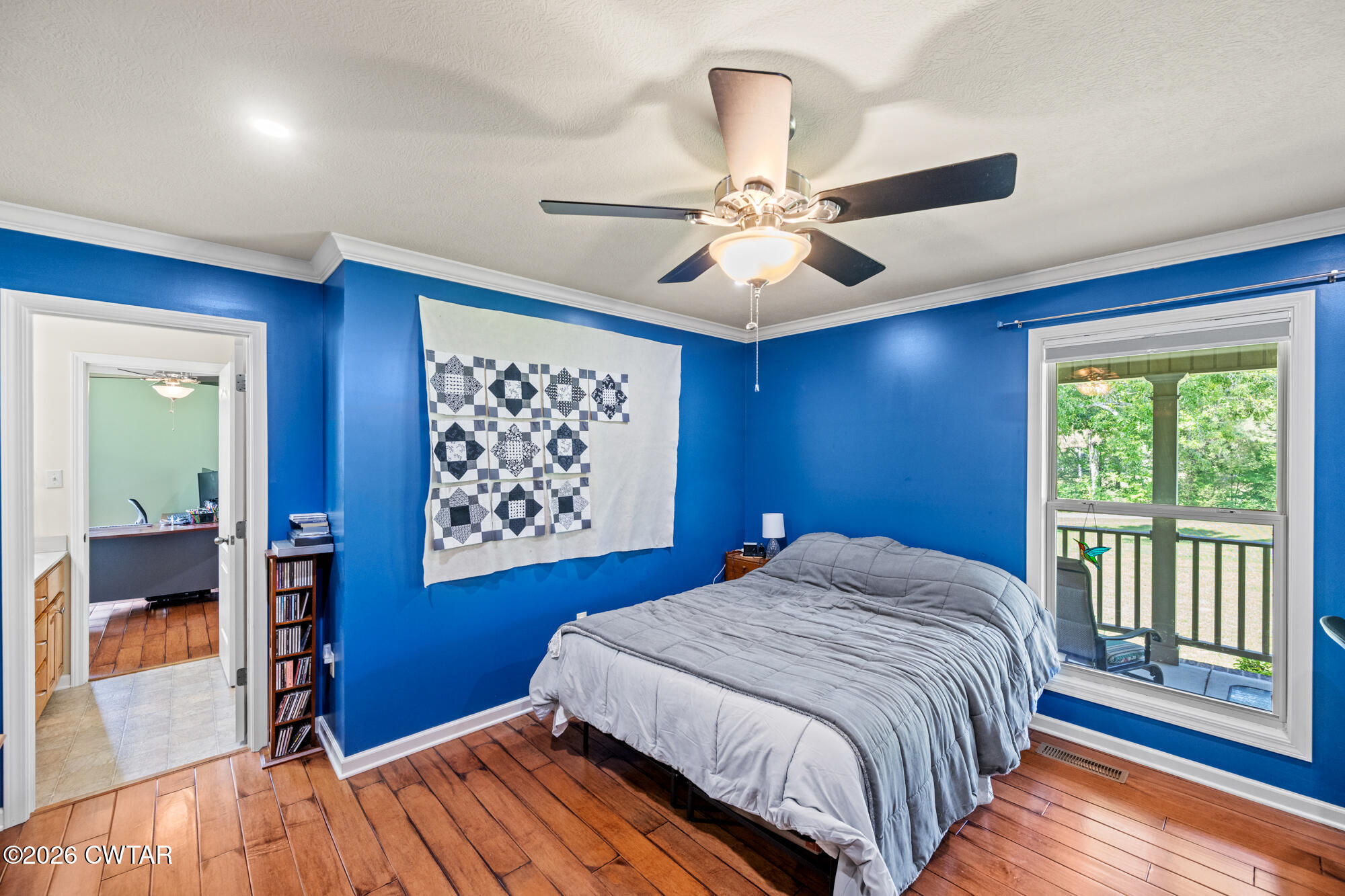 492 Joe Horton Road Lexington, TN 38351 - Photo 26 of 49 a bedroom with a large bed chandelier and a window