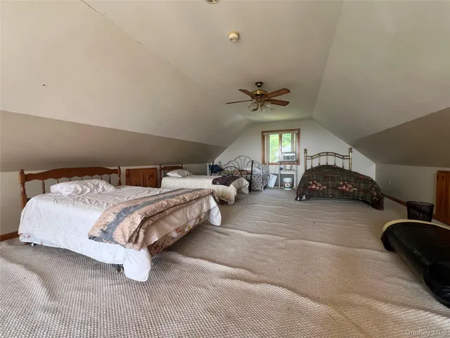 a spacious bedroom with a bed and a chandelier