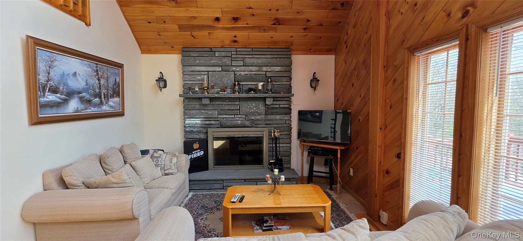 125 Woods Road Barryville, NY 12719 - Photo 13 of 34 a living room with furniture and a fireplace