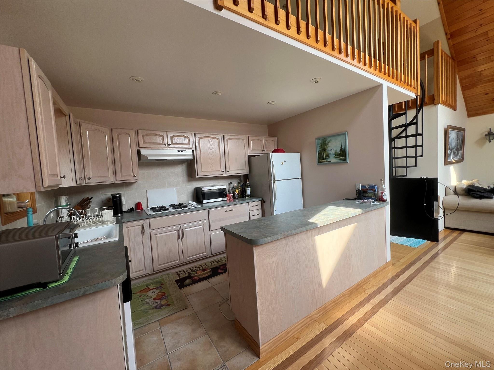 125 Woods Road Barryville, NY 12719 - Photo 2 of 25 a kitchen with cabinets a sink and appliances