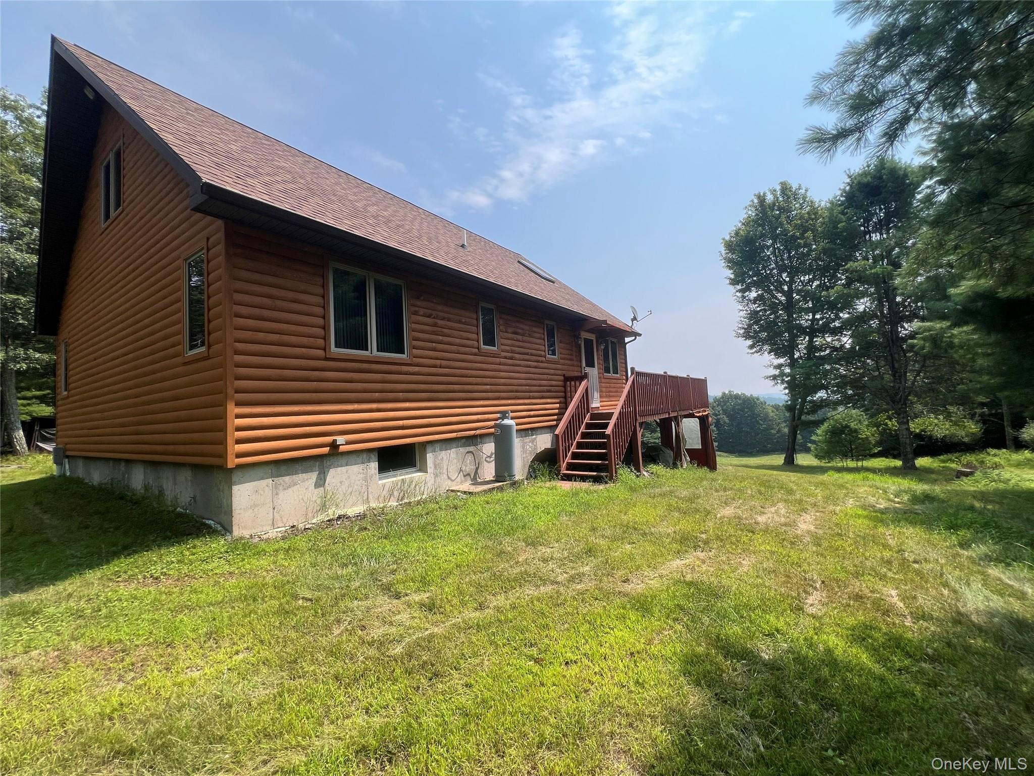 125 Woods Road Barryville, NY 12719 - Photo 23 of 25 a backyard of a house with table and chairs