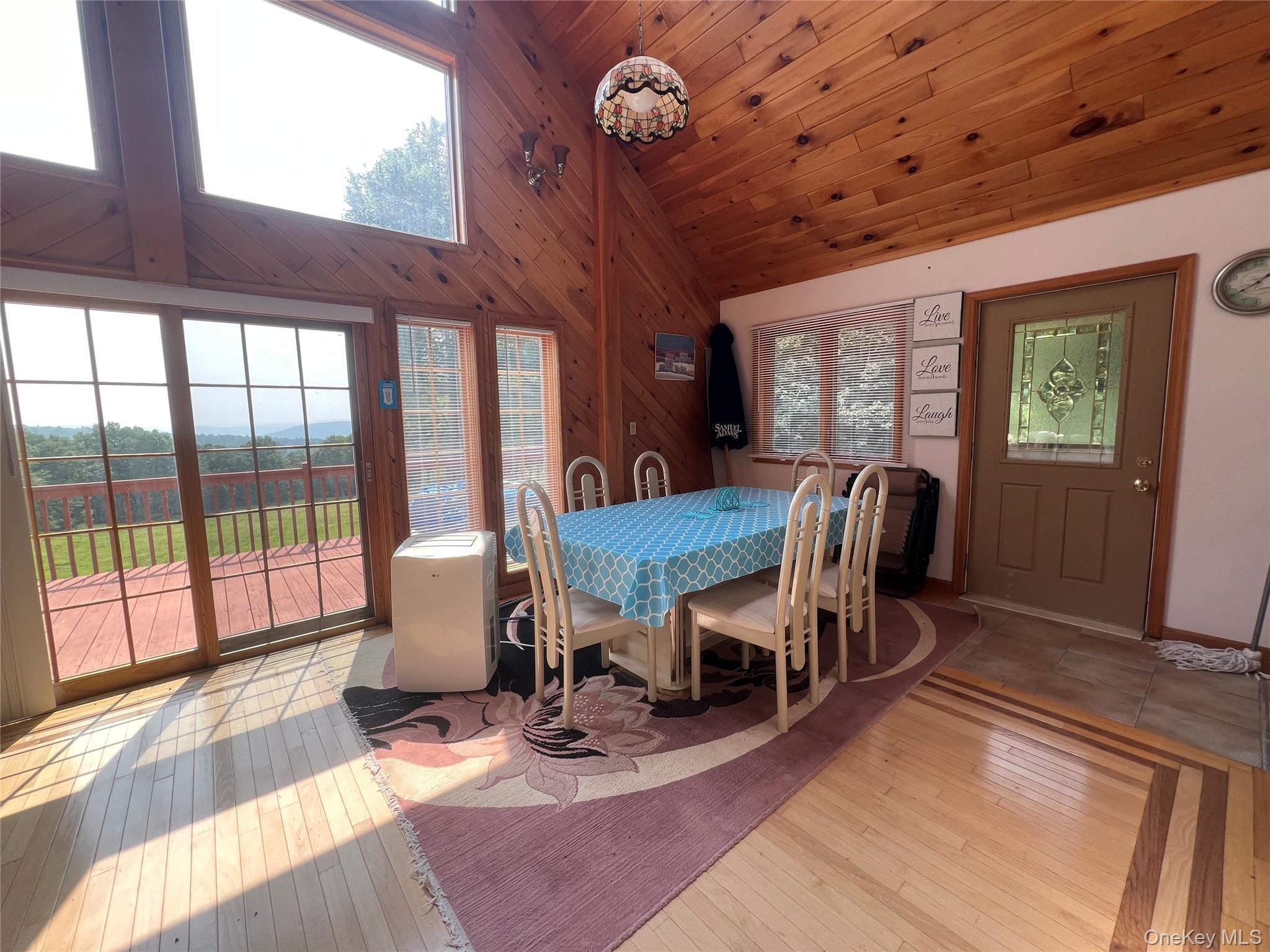 125 Woods Road Barryville, NY 12719 - Photo 5 of 25 a dining room with furniture a chandelier and wooden floor
