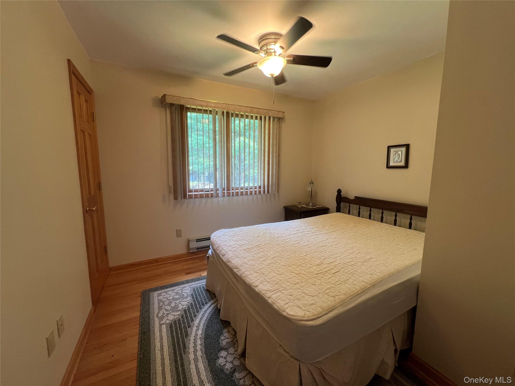 125 Woods Road Barryville, NY 12719 - Photo 10 of 25 a bedroom with a bed and a chandelier