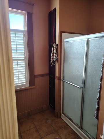 5264 West 5500th Street South Hooper, UT 84315 - Photo 15 of 20 Full bathroom with wainscoting, a stall shower, and wood walls