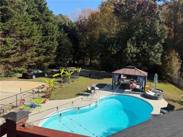 a view of a swimming pool with a patio