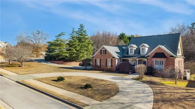 an aerial view of a house with swimming pool and sitting area