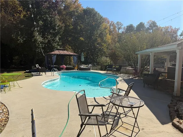 a view of a backyard with sitting area