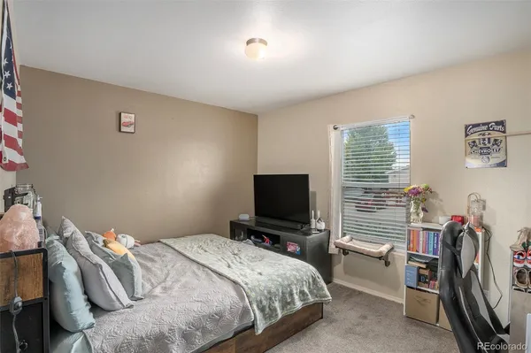 a bedroom with bed and a window