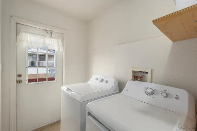 a view of a house with wooden fence