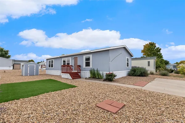 a front view of a house with a yard and porch