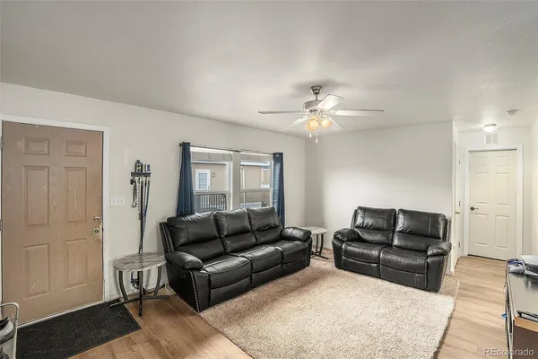 a living room with furniture and a lamp