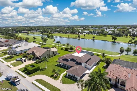 an aerial view of a house with a lake view