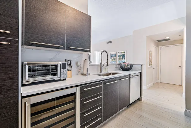 a kitchen with stainless steel appliances a sink and cabinets