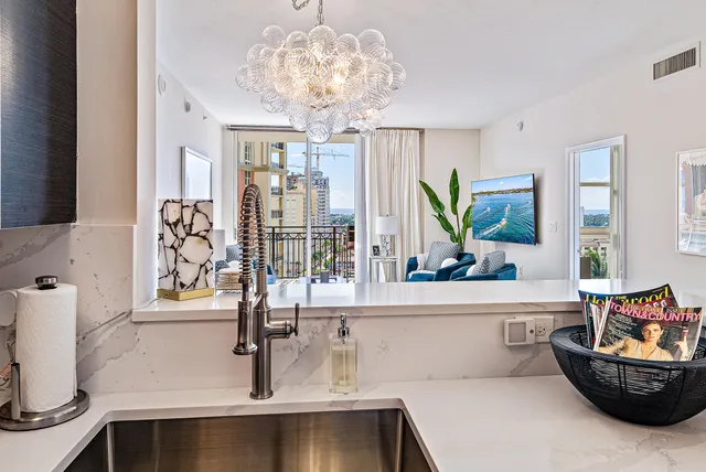 a living room with furniture and a chandelier