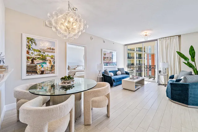 a living room with fireplace furniture and a chandelier
