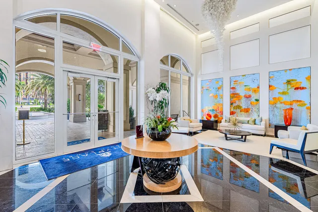 a view of a dining room with furniture a chandelier and wooden floor