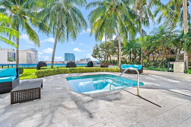 a view of backyard with swimming pool and outdoor seating