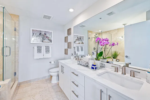 a bathroom with a sink mirror and toilet