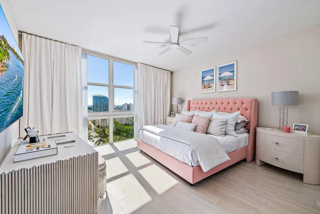 a bedroom with a bed and a large window