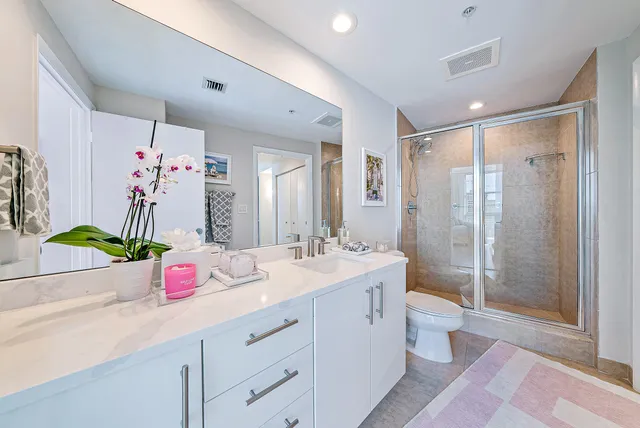 a bathroom with a sink mirror and vanity
