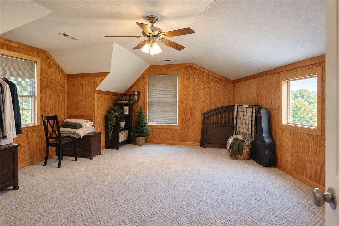 2420 Rainey Road Starr, SC 29684 - Photo 26 of 36 Rich wood paneling warms this vaulted space complete with plush carpeting and natural light.
