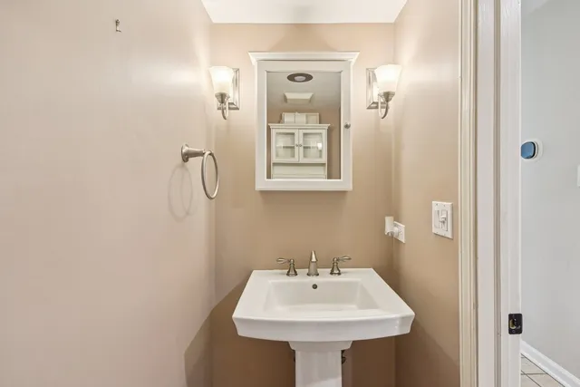 a bathroom with a sink a mirror and a shower