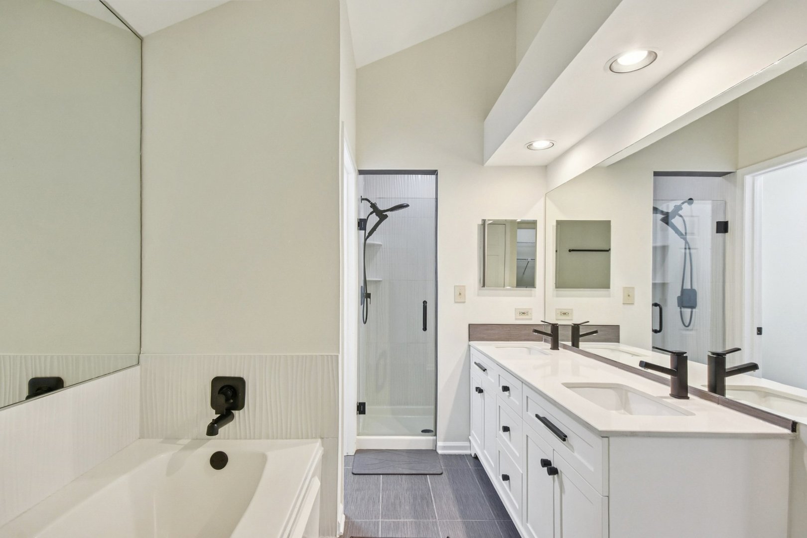 22 Ascot Circle Schaumburg, IL 60194 - Photo 16 of 25 a bathroom with a double vanity sink a mirror and a bathtub