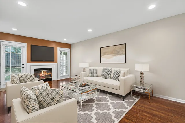 a living room with furniture a fireplace and a flat screen tv