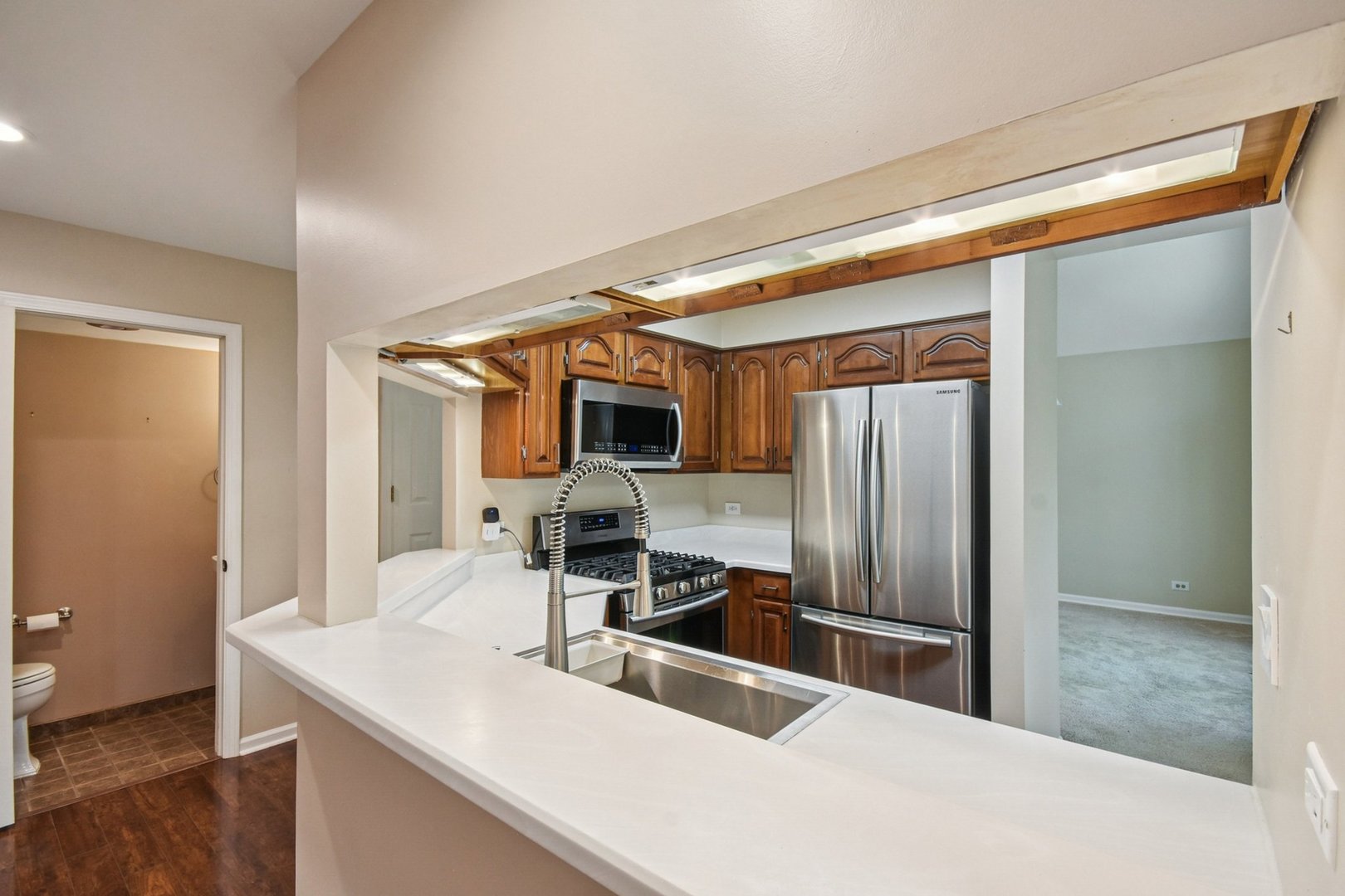 22 Ascot Circle Schaumburg, IL 60194 - Photo 7 of 25 a kitchen with stainless steel appliances a sink and a refrigerator
