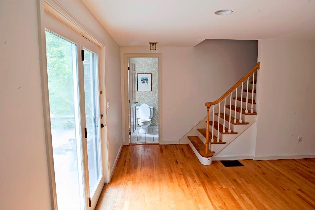 178 Foreside Road Cumberland, ME 04110 - Photo 25 of 31 Living Rm, Doors to deck, 1/2 bath &...