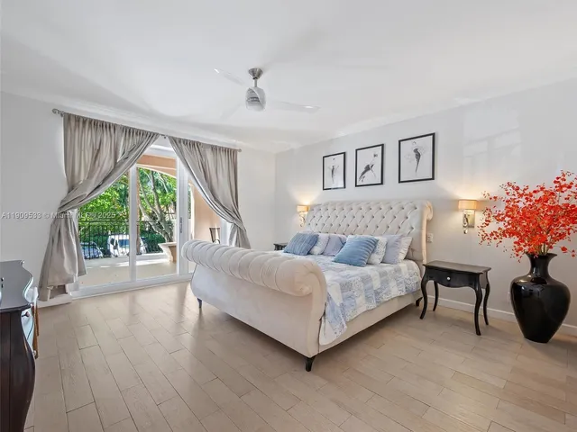 a spacious bedroom with a bed and a potted plant