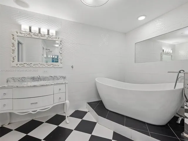 a bedroom with a bed a couch and a window