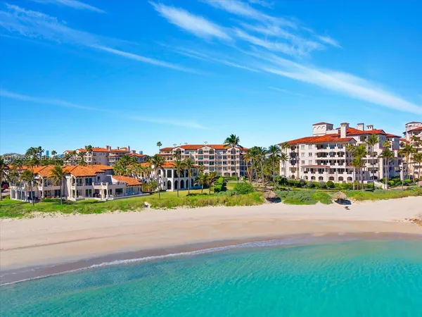a view of a patio with table and chairs under an umbrella
