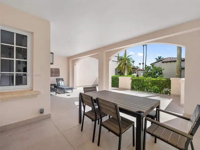 a view of a dining room with furniture and a potted plant