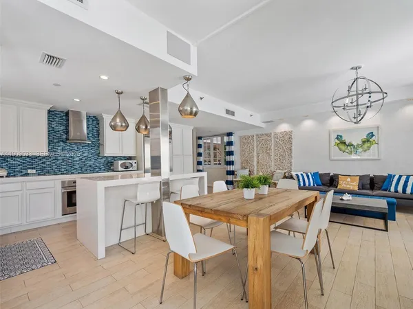 a view of a dining room with furniture kitchen and chandelier