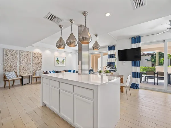 a large kitchen with lots of counter space and painting on the wall