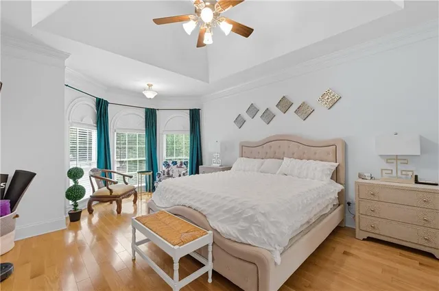 a bedroom with a bed and ceiling fan