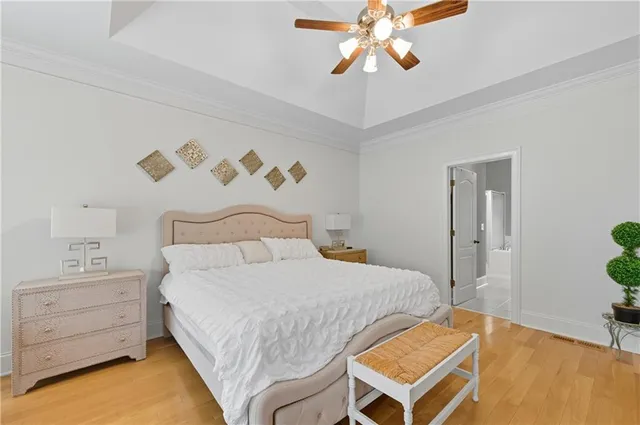 a bathroom with a tub a sink and a large mirror