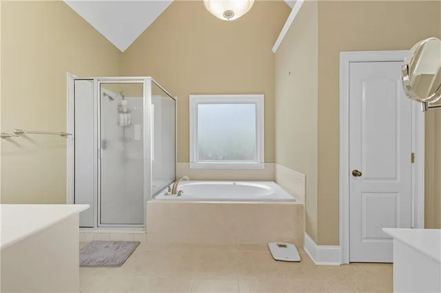 a en suite bathroom with a double vanity sink and a mirror