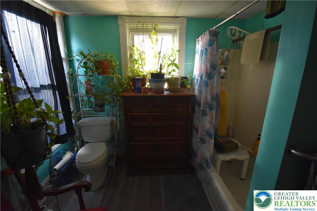 22 South Raspberry Street Easton, PA 18042 - Photo 7 of 16 a bathroom with sink a mirror a toilet and shower