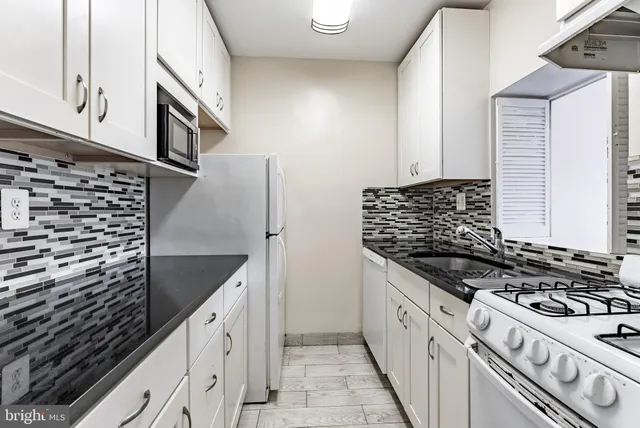 a kitchen with stainless steel appliances granite countertop a stove and a sink