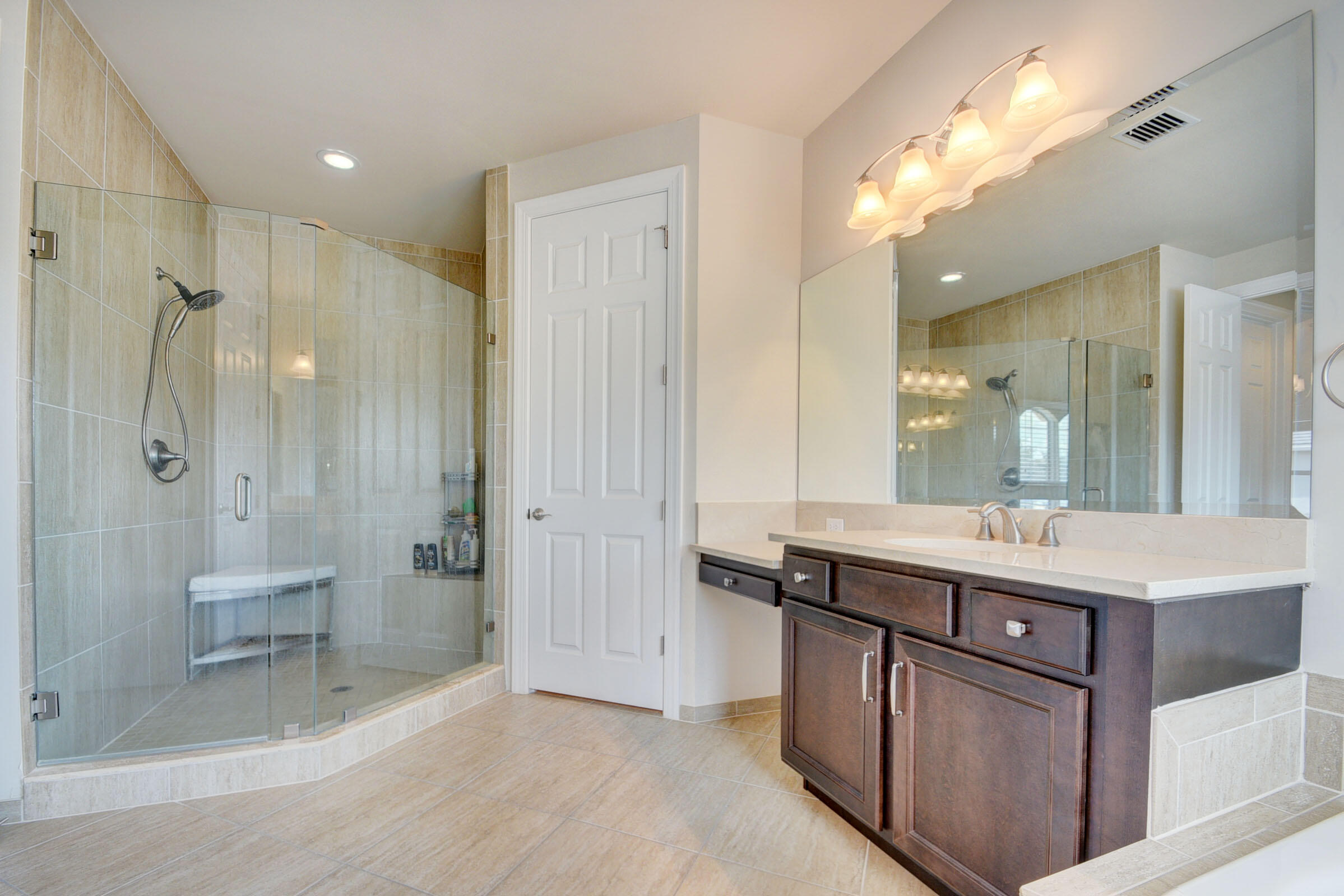 8625 Wellington View Drive Royal Palm Beach, FL 33411 - Photo 23 of 54 a spacious bathroom with a shower sink and mirror