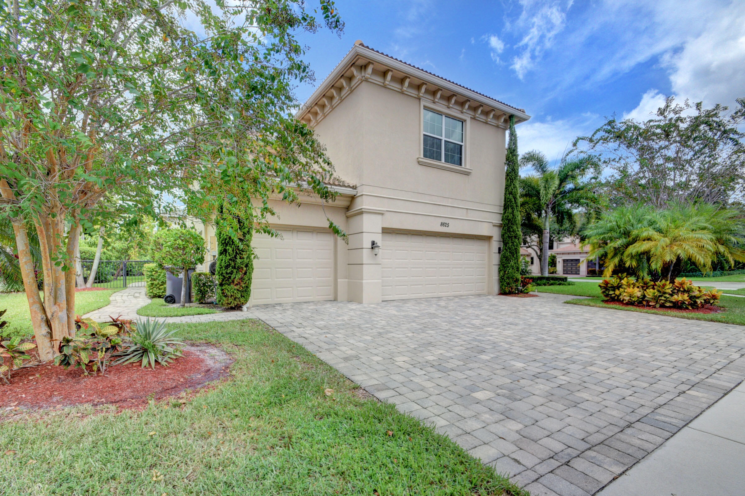 8625 Wellington View Drive Royal Palm Beach, FL 33411 - Photo 3 of 54 a front view of a house with a yard and garage