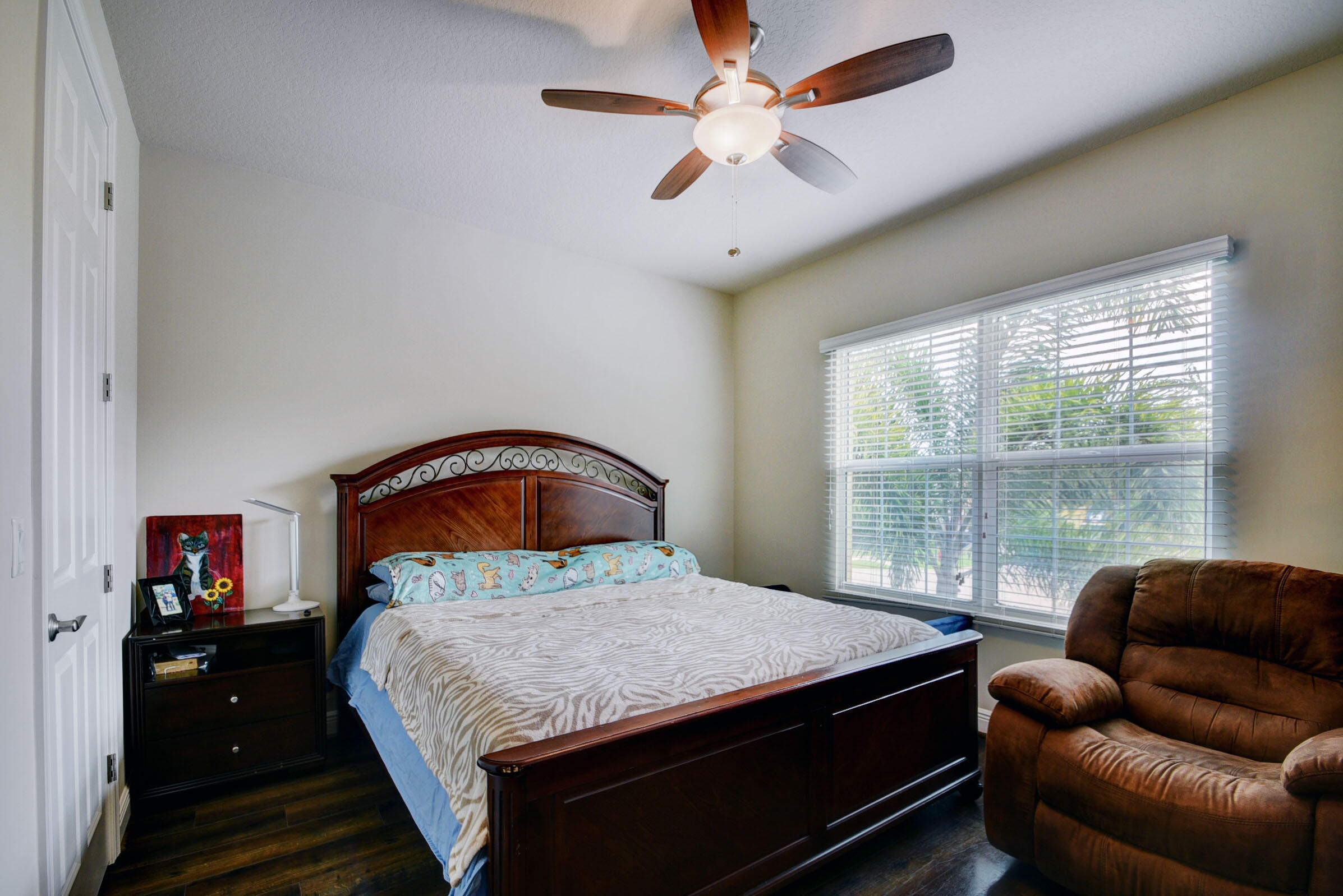 8625 Wellington View Drive Royal Palm Beach, FL 33411 - Photo 33 of 54 a bedroom with a large bed and a large window