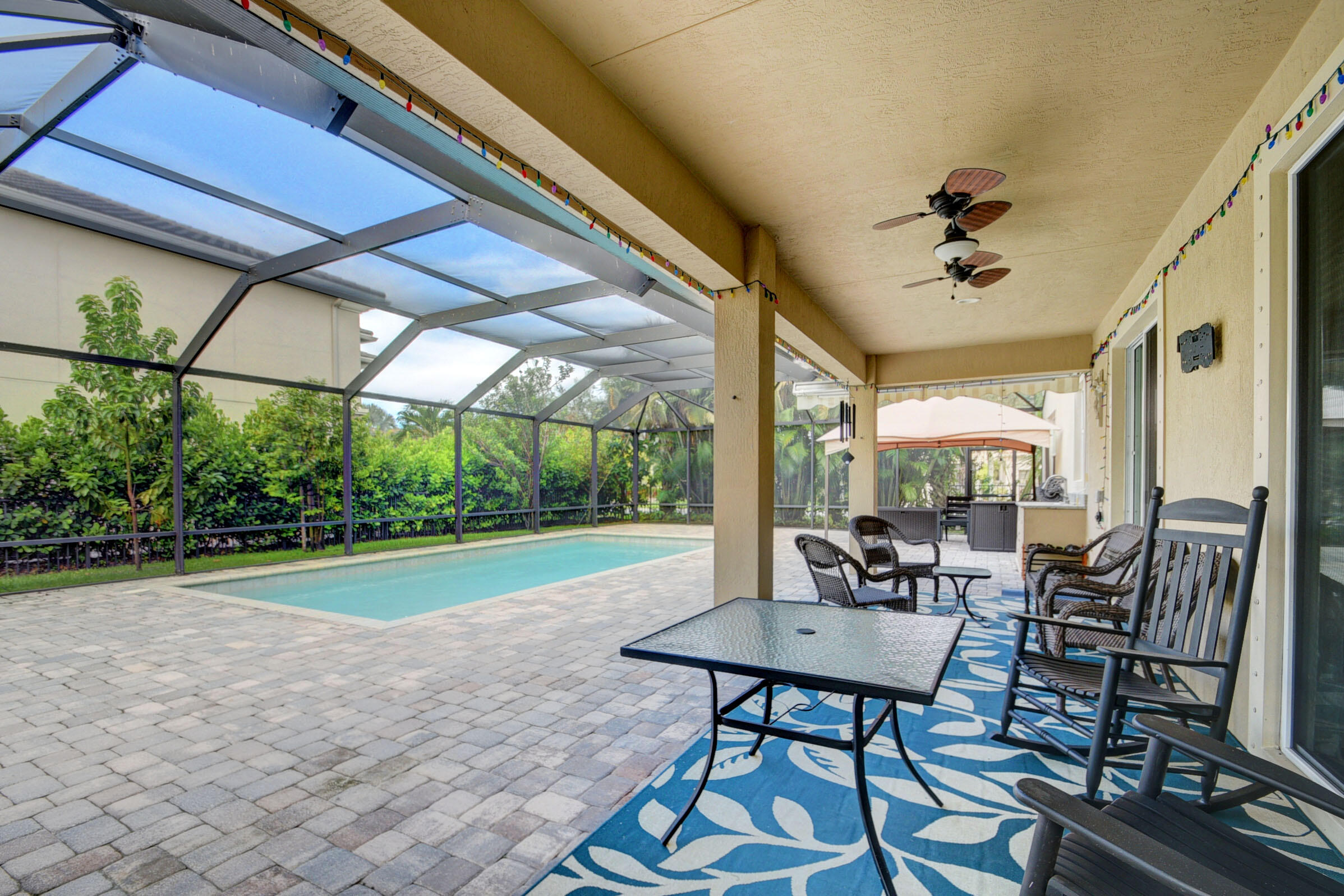 8625 Wellington View Drive Royal Palm Beach, FL 33411 - Photo 37 of 54 a view of a patio with a dining table and chairs