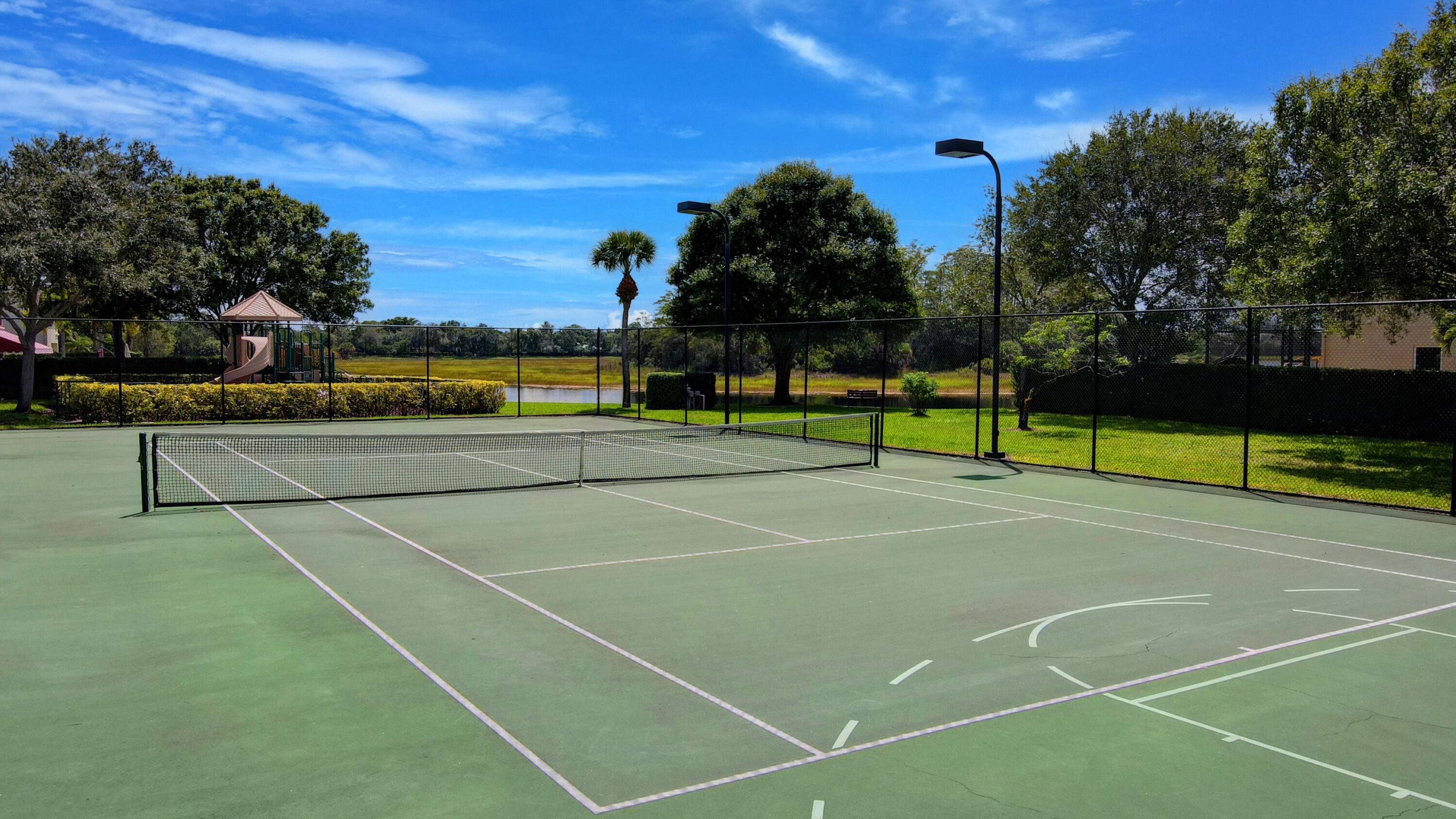 8625 Wellington View Drive Royal Palm Beach, FL 33411 - Photo 47 of 54 a view of an outdoor space and tennis court