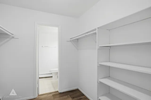 a bathroom with a sink a light fixture and a toilet